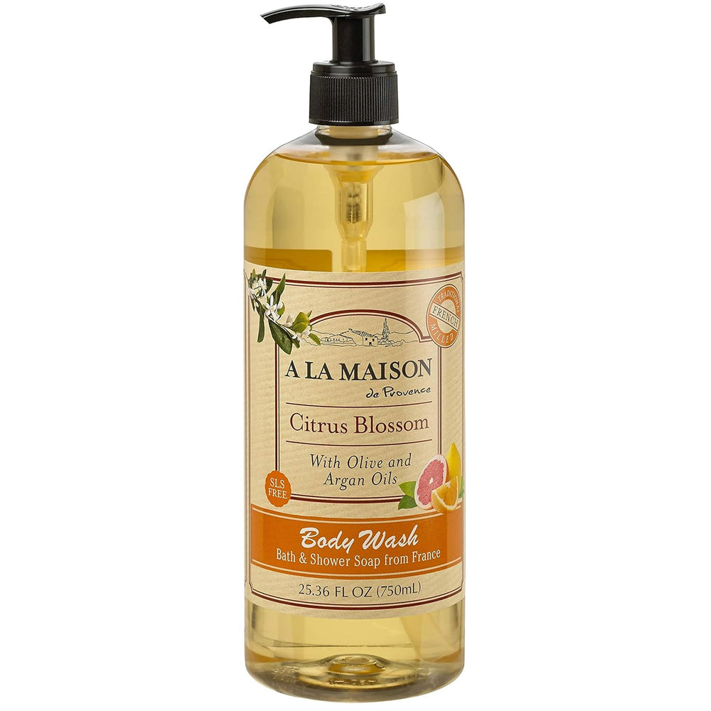 A LA MAISON Citrus Blossom body wash bottle on a bath shelf, refreshing daily cleanse.