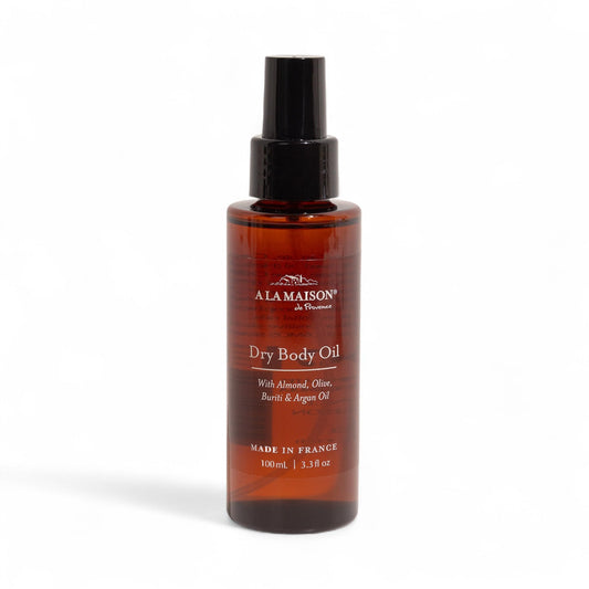 A LA MAISON Dry Body Oil Spray bottle pour with argan oil for lightweight hydration.