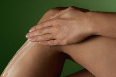 Applying balm to dry elbows and knees for targeted hydration