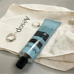 Aesop Reverence Aromatique Hand Balm aroma close-up highlights woodsy, smoky notes.