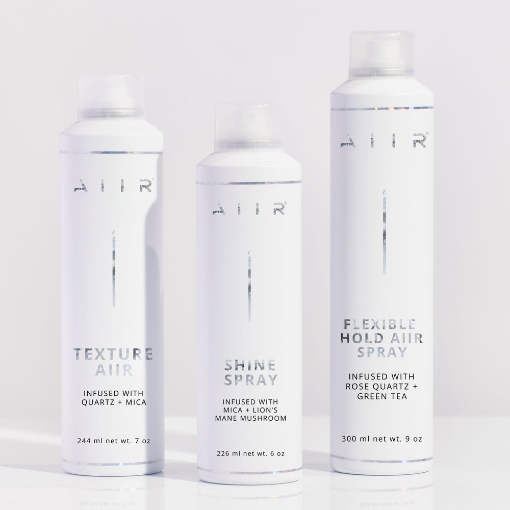 AIIR Shine Spray on curls providing humidity resistance and shine.