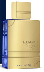 Close-up of Amber Oud Blue Edition base notes featuring sandalwood and cedar warmth.