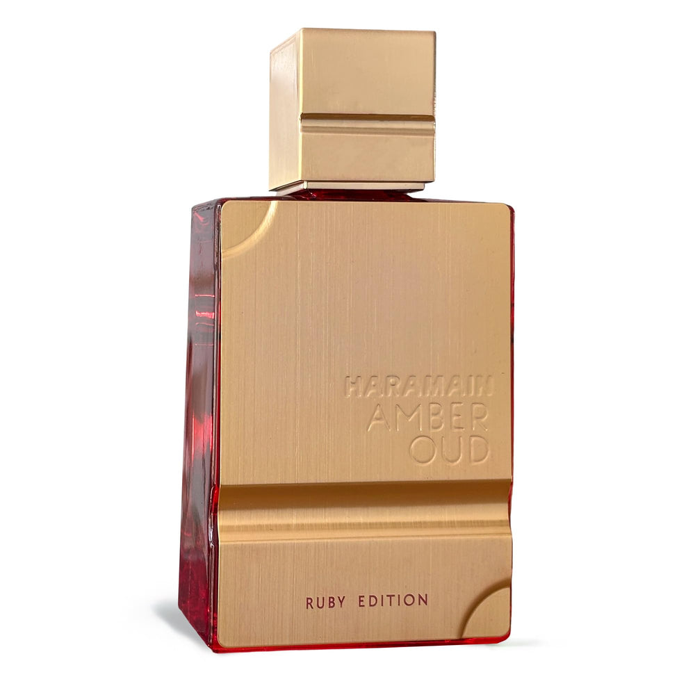 Al Haramain Amber Oud Ruby Edition amber warmth visible in dim lighting.
