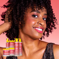 Hands applying Alaffia Beautiful Curls Shampoo to wet hair