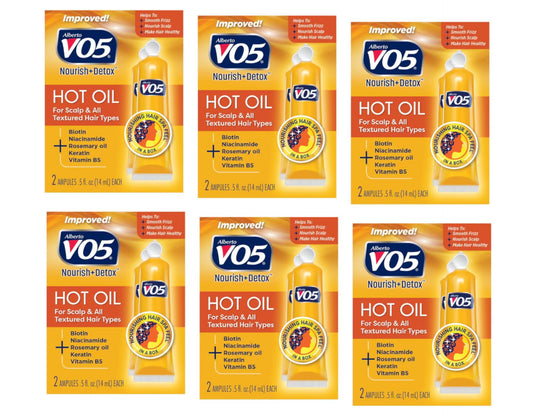 Alberto VO5 moisturizing hot oil tubes in hand for smooth, hydrated hair.