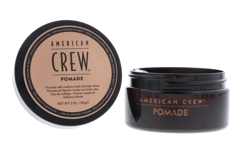 American Crew pomade application on dry hair for controlled, polished looks.