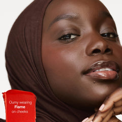 AMI COLÉ Desert Date Cream Multistick Flame applied to lips for sheer color