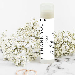 Step-by-step DIY assembly of lip balm favors with adhesive stickers.