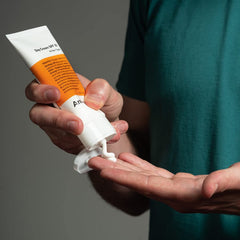 Anthony Day Cream SPF 30 tube on hand demonstrates quick-absorbing, non-greasy finish.