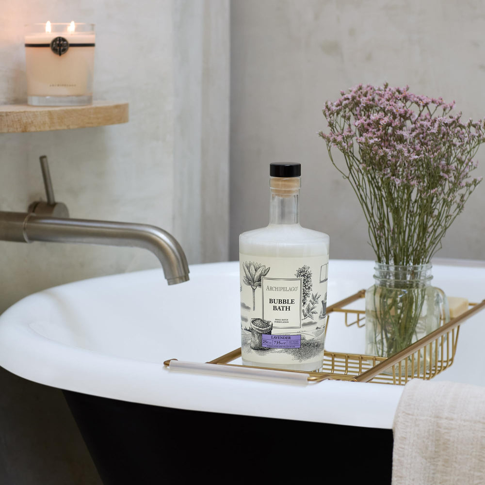 Archipelago Botanicals Lavender Bubble Bath on a bath shelf signaling a spa-like routine.