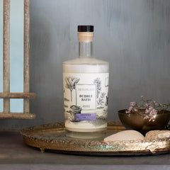 Archipelago Botanicals Lavender Bubble Bath being poured to release luxurious bubbles.