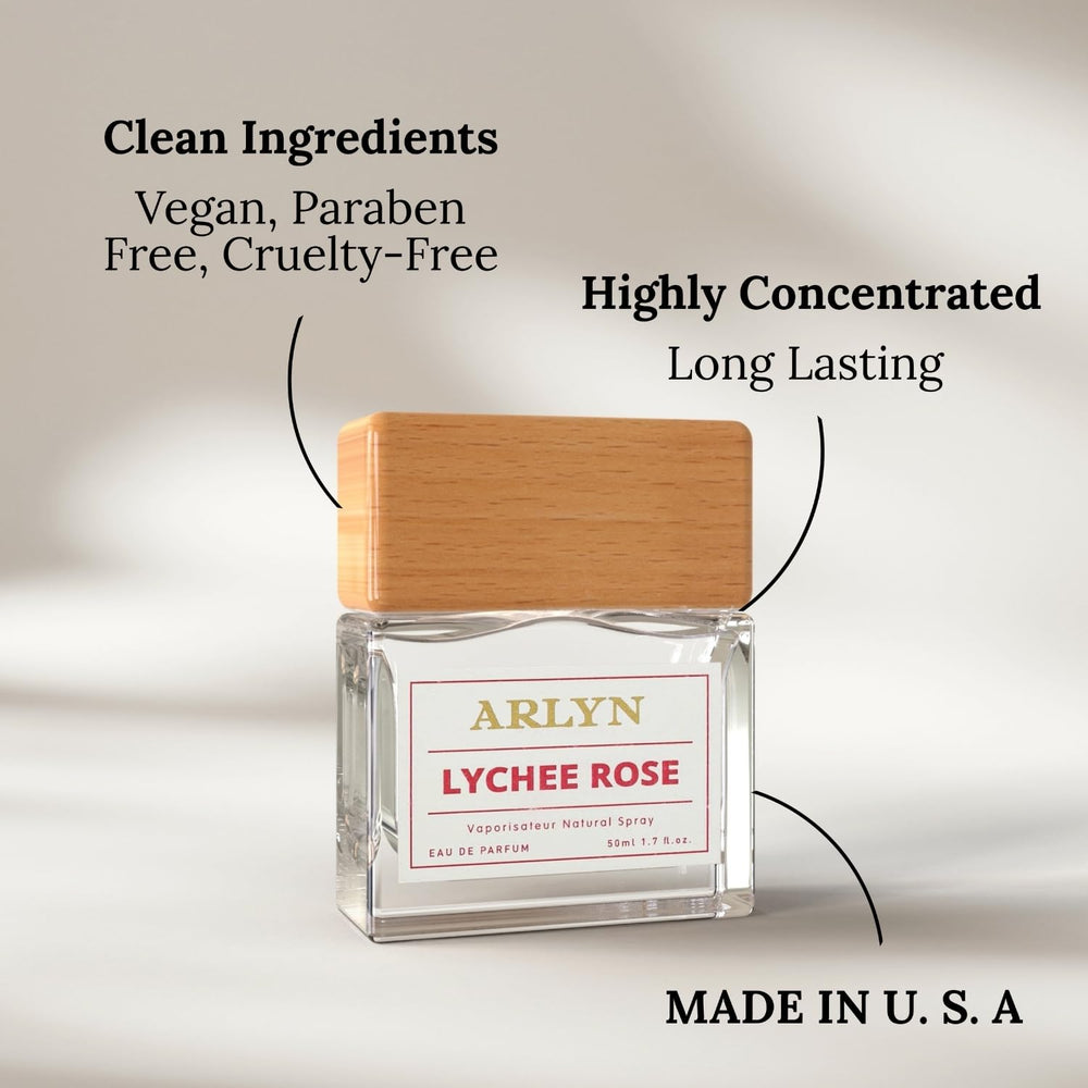 ARLYN Lychee Rose lifestyle shot with soft pink petals around the bottle.
