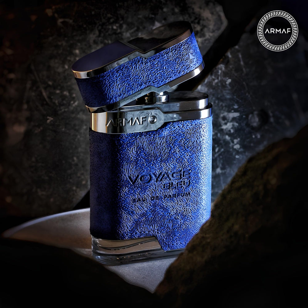 Armaf Voyage Blue flatlay, bottle with natural-toned styling.