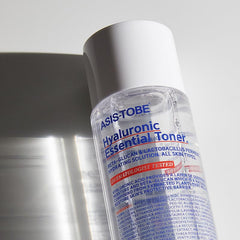 ASIS-TOBE Hyaluronic Essential Toner being patted into skin for hydration.