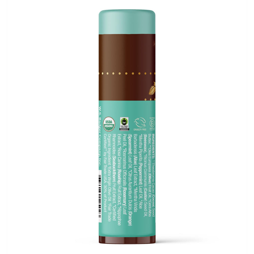 Applying Badger lip balm shows creamy texture and minty aroma on lips.