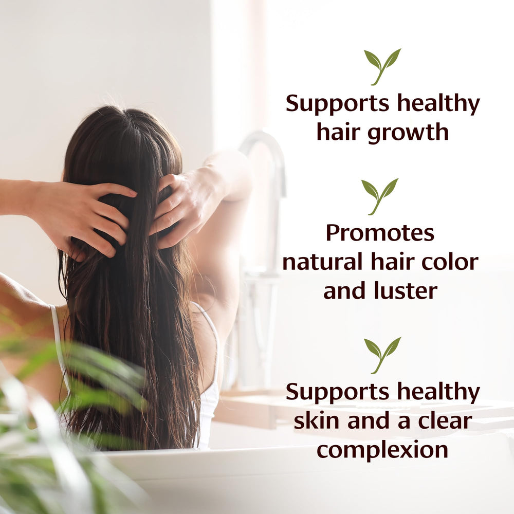 Banyan Botanicals Bhringaraj Oil pour image showing easy scalp application.