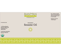 Close-up pour spout on Banyan Botanicals sesame oil for easy use.
