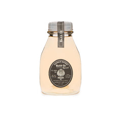 Barr-Co Reserve Bubble Bath Elixir bottle with earthy aroma for a calming soak.