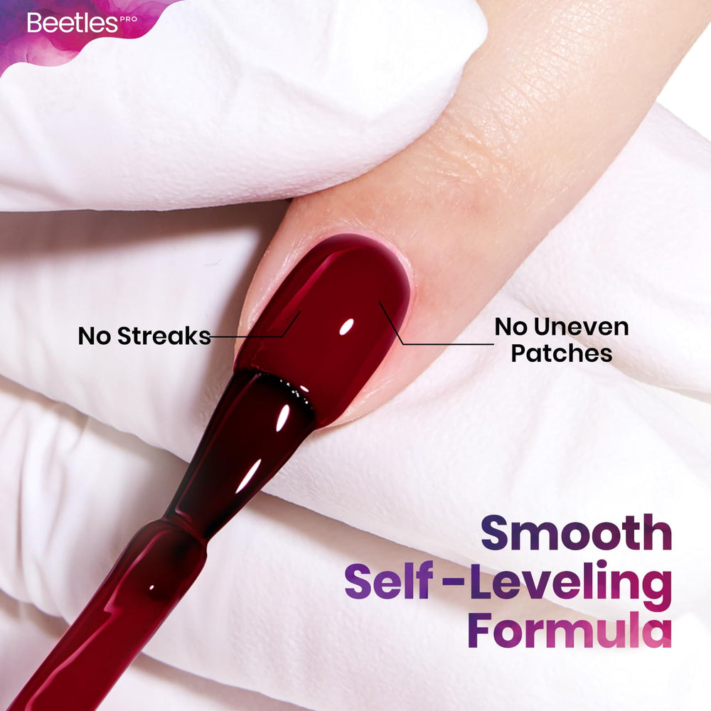 Beetles Pro red gel polish under UV lamp cures for durable salon finish.