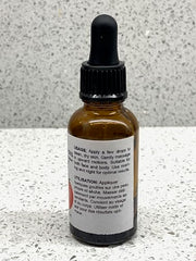 Best Nature's Cosmetics tomato seed oil dropper close-up for skin nourishment.