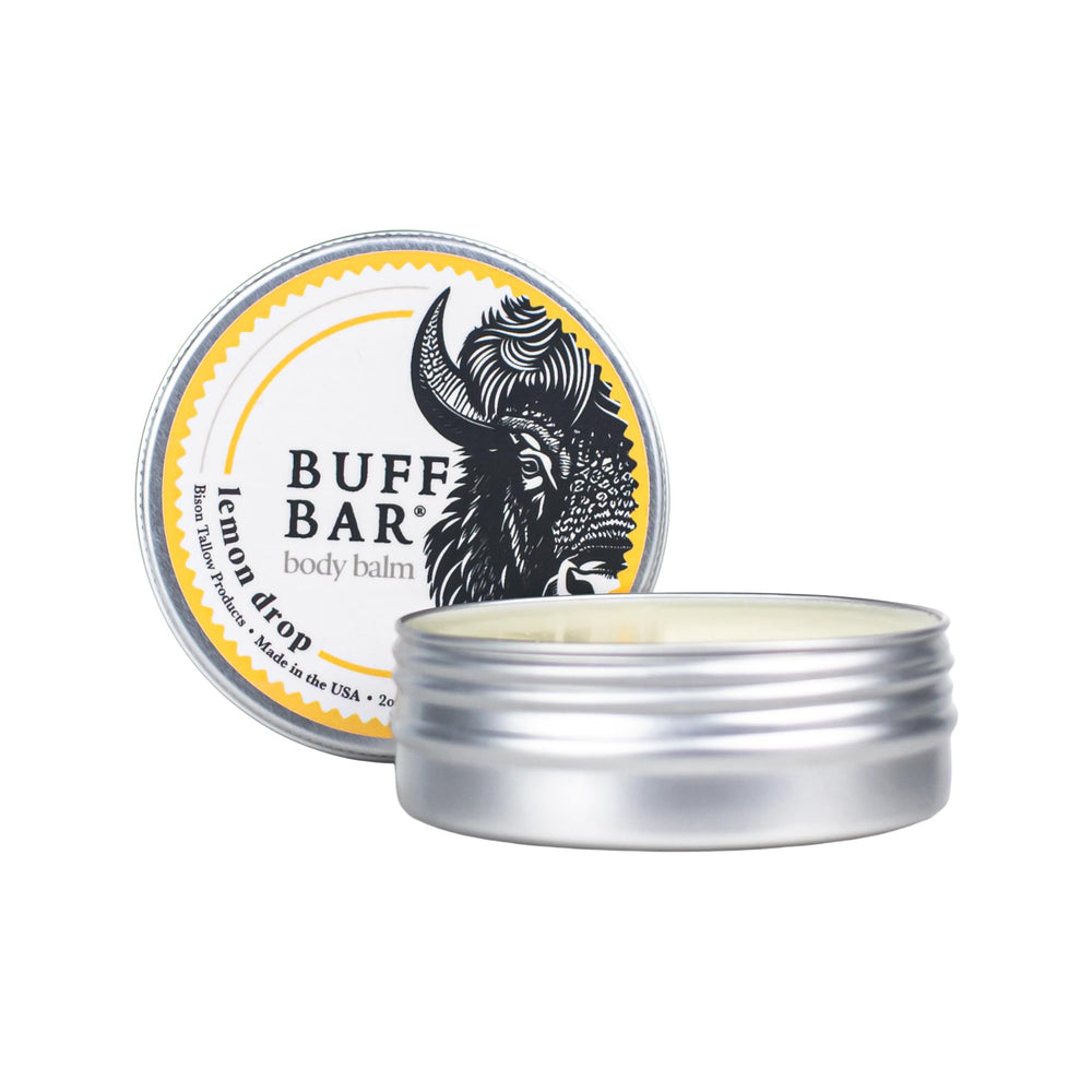 Packaging of Buff Bar Lemon Drop 2 oz tin is portable for travel skincare routines.