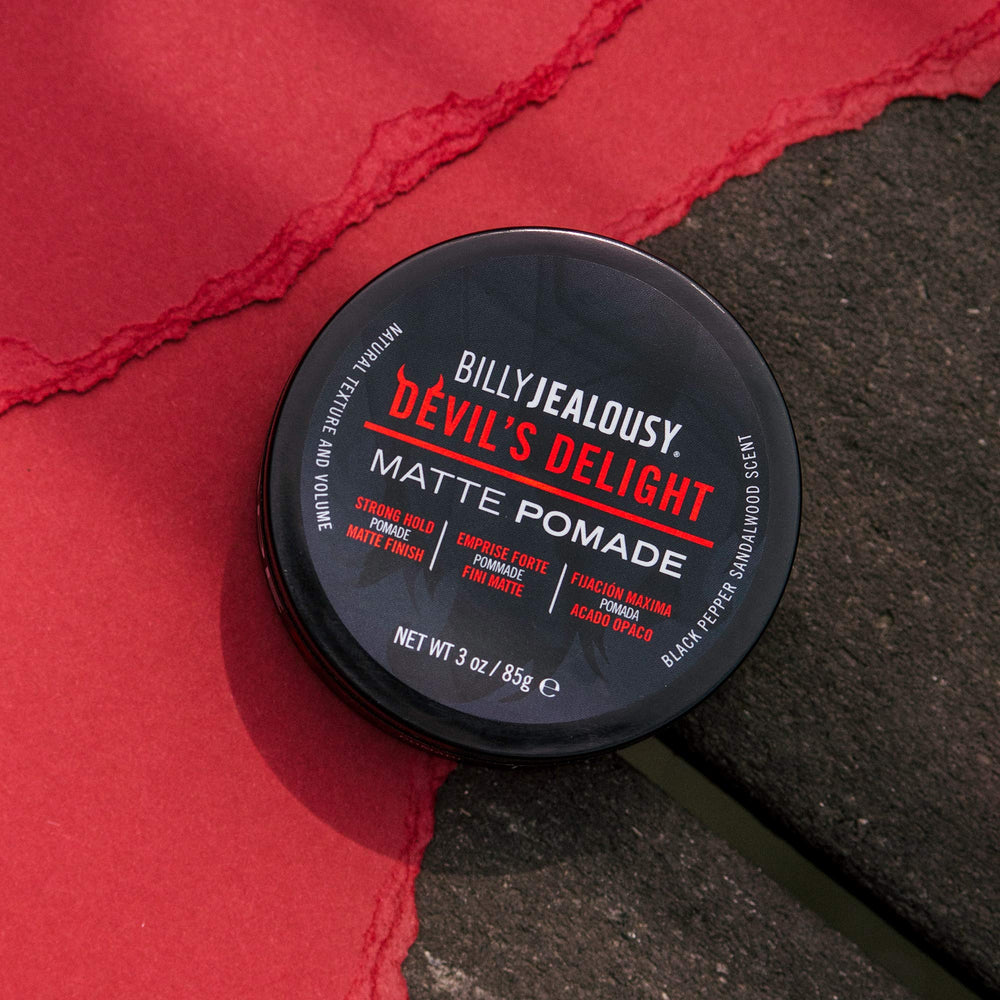 Billy Jealousy Devil's Delight hands applying pomade for even distribution.