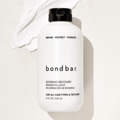 Bondbar Treatment hands applying cream on hair for even moisture distribution