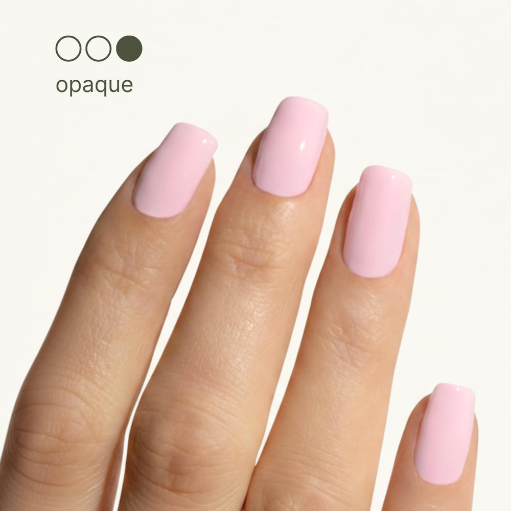 Nail close-up showing peachy-pink shine and refined surface texture.