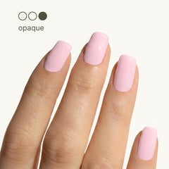 Nail close-up showing peachy-pink shine and refined surface texture.