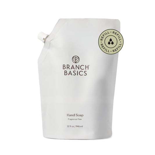 Branch Basics Gel Hand Soap Refill 32oz pouch being poured into the bottle for easy refills.