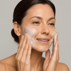Applying Cellcosmet Gentle Cream Cleanser to remove makeup gently from the face.