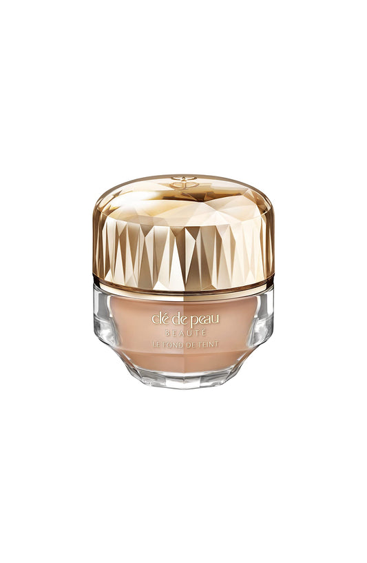Clé de Peau Beauté Foundation SPF 22 bottle demonstrates radiant, even-toned skin.