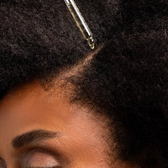 Cliganic hemp seed oil applying on hair demonstrates nourishing treatment for shine.