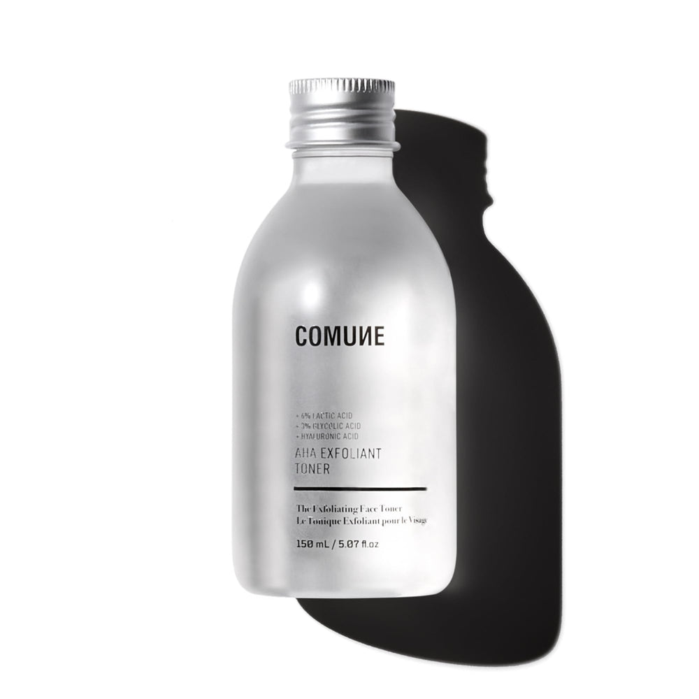 COMUNE AHA Exfoliant Toner bottle pour showing gentle exfoliation and pore refinement.
