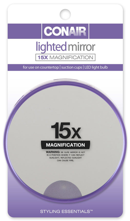 Conair 15x magnification lighted suction mirror attached to a smooth surface for precise makeup detail