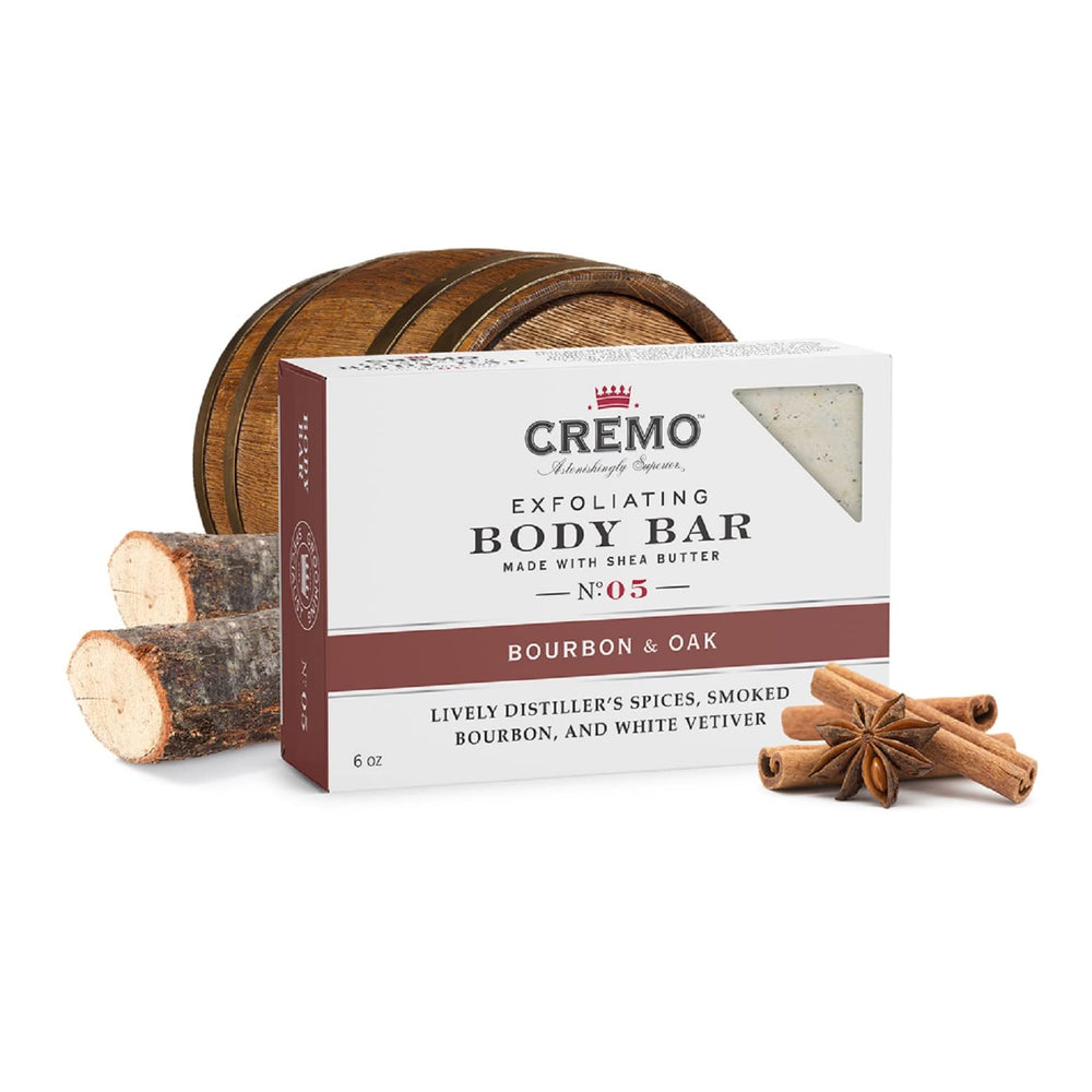 Cremo Bourbon and Oak exfoliating bar on bathroom shelf in natural light