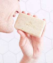 Cremo Bourbon and Oak exfoliating bar pack on a vanity display