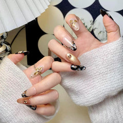 CTTHNBD almond nails black gold design closeup highlights bold style for events.