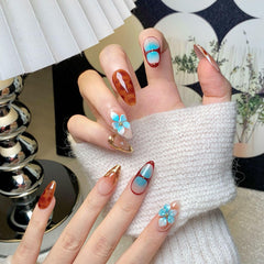 CTTHNBD almond brown ombre nails with decorative flower detail