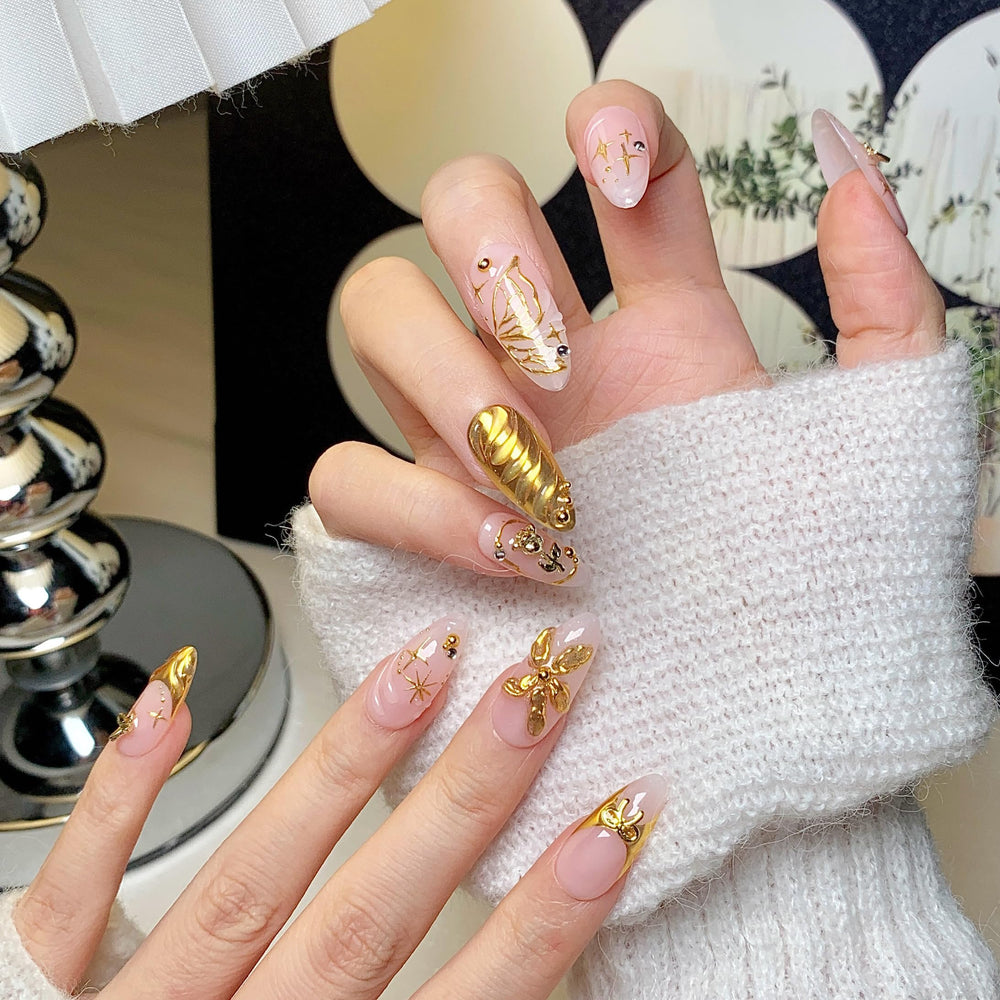 CTTHNBD press-on almond nails on hand showing gold bow accent for daily wear