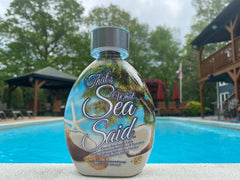 DARK TANS EXCLUSIVE Outdoor beach scene highlighting natural bronze glow.