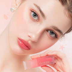 dasique Juicy Dewy Tint lip swatch with vibrant coral shine.