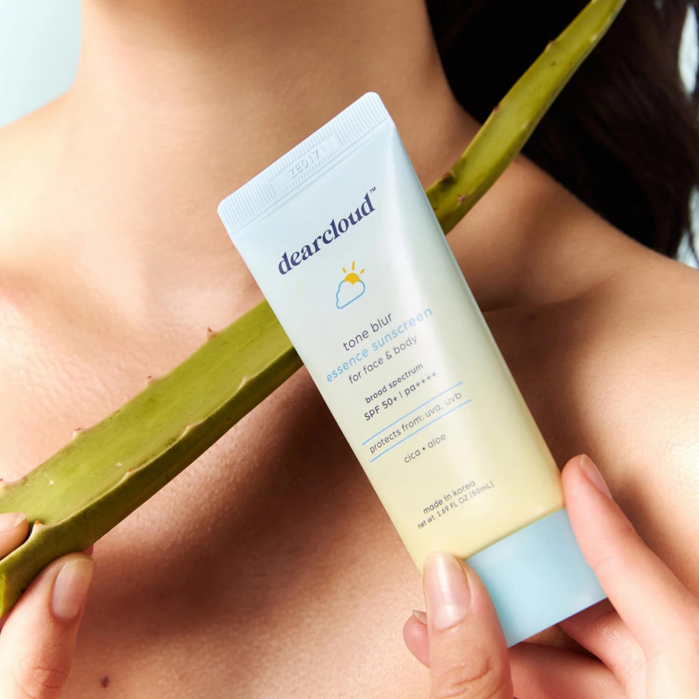 Packaging display of Dearcloud Tone Blur Essence Sunscreen emphasizing vegan and cruelty-free branding