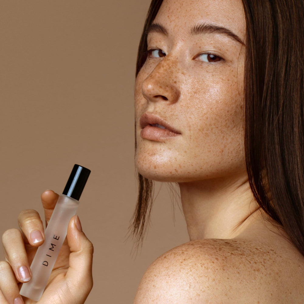 DIME Dans Les Bois travel-size spray held for easy daytime touch-ups.