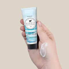 Close-up of hands applying Dionis Goat Milk Hand Cream Ocean Mist for silky skin