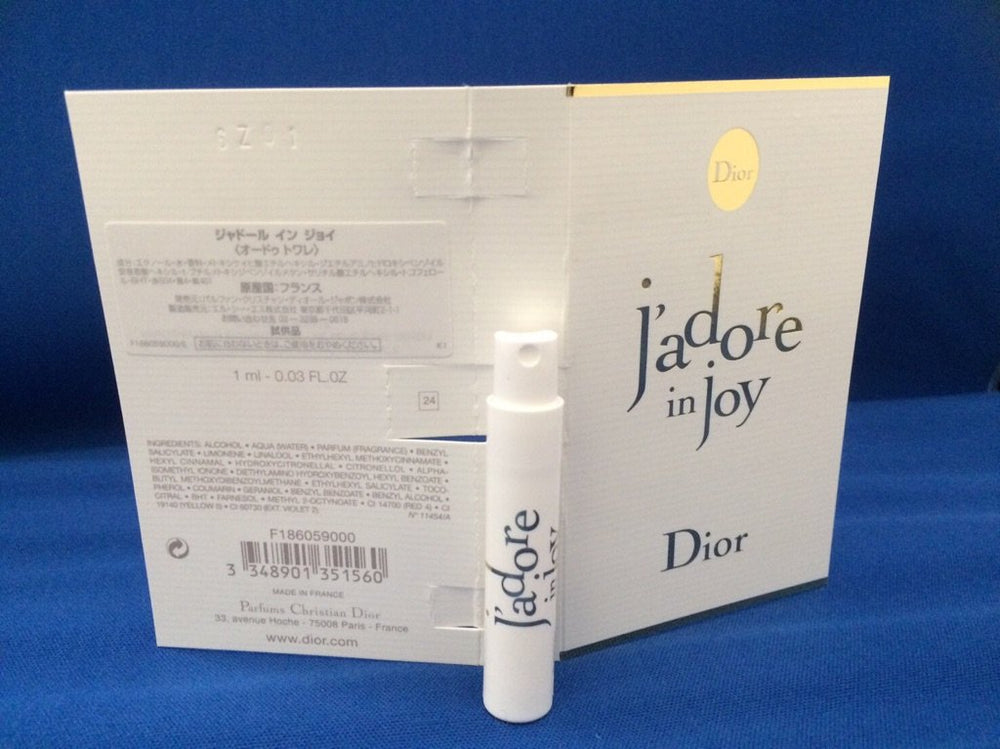 Dior J'adore In Joy mini bottle spray highlighting a travel-sized fragrance