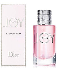 Dior Joy EDP bottle close-up highlights vibrant pink juice for radiant allure.