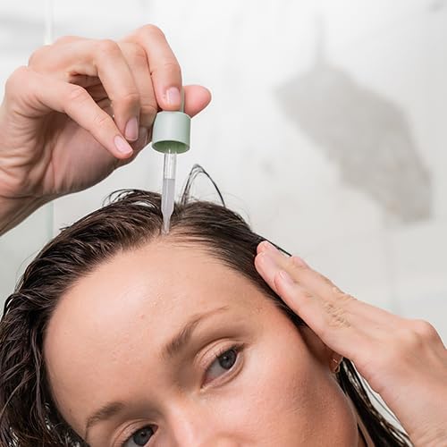 Divi Scalp Serum shake-before-use action illustrating preparation step.