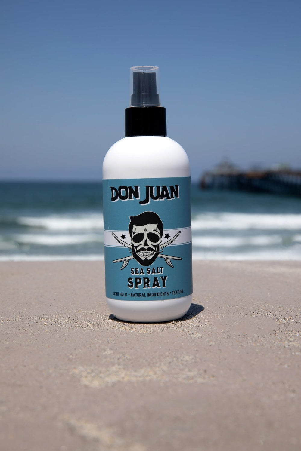 Surf wax scent from Don Juan Sea Salt Hair Spray enhances styling vibe.