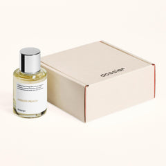 Dossier Ambery Peach hand application, compact bottle for on-the-go fragrance touch-ups.